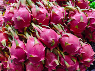 Vibrant Pink Dragon Fruits Stacked in a Fresh Market Display