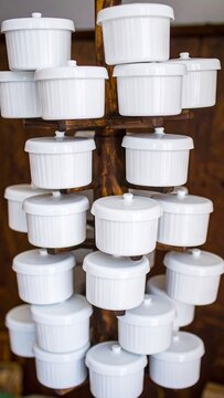 White ceramic ramekins on a wooden display