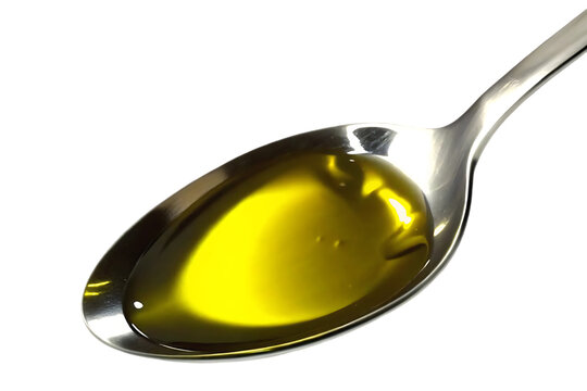 Close up of a metal spoon filled with golden olive oil isolated on transparent background