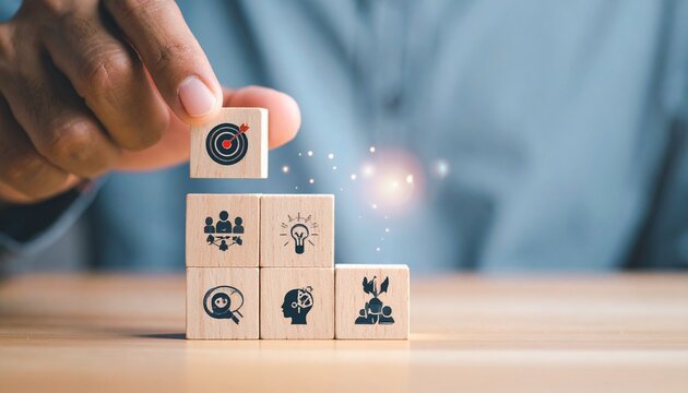 Hand arranging grid of twelve business-themed icon blocks—megaphone lifted above podium, gear, rocket, chart evoke strategy, innovation, and communication in minimalist organizational symbolism compos