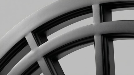 Modern matte black window frame with curved top and subdivided glass segments on neutral background, emphasizing clean lines, textured finish, and minimalist design
