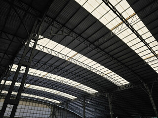 Modern Industrial Roof Structure with Translucent Panels and Steel Trusses.