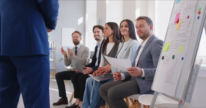 Group of a business people team in an office applauding and celebrating success during a meeting, conference, or briefing. Teamwork, collaboration, and communication contribute to this achievement.