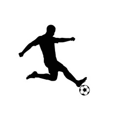 Fototapeta premium Silhouette of a soccer player kicking a soccer ball in midair.