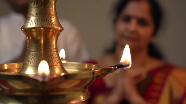Indian Woman in Saree Performing Aarti with Oil Lamp and Praying Hands