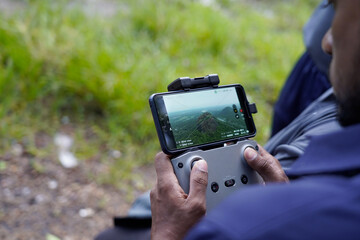 Videography Drone Pilot Holding Remote Controller Outdoors