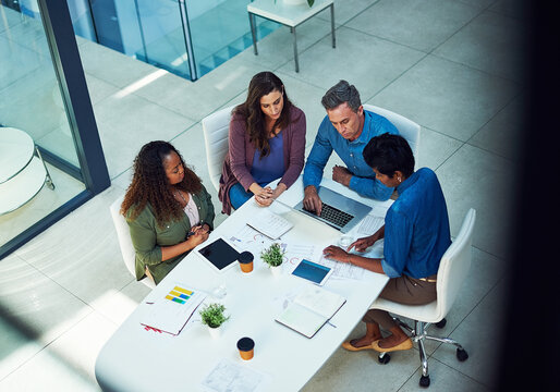 Data, infographic and laptop with business people in office together for collaboration. Analytics, charts and technology with social media team at work for discussion or project management from above