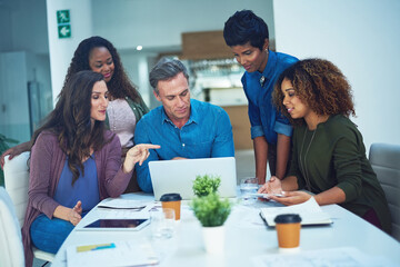 Meeting, pointing and people in office with laptop, collaboration or advice for project report. Discussion, planning and employees at table with tech, problem solving or idea for progress review