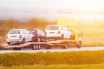 Tow truck towing cars along highway