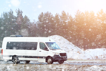 Snowy road with passenger van in motion © AlexGo