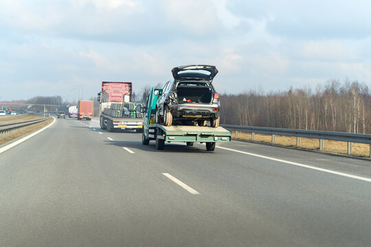 Fototapeta Towing service carrying wrecked vehicle