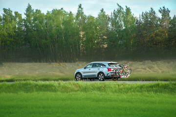 Fototapeta premium Modern vehicle traveling with bikes on freeway