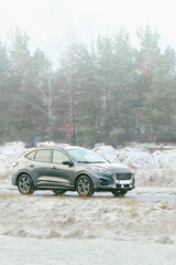 Winter road with electric plug-in car