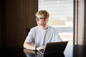 Young man working at a desk in a modern office space