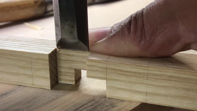 Refining a woodworking joint with a chisel and mallet