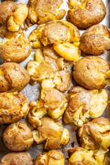 Baked smashed potatoes on tray