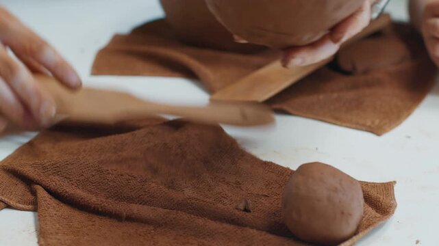 Person works with the clay in the pottery workshop during masterclass