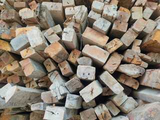 Close-up of a pile of small wooden blocks stacked together, representing natural material, construction industry, and carpentry.