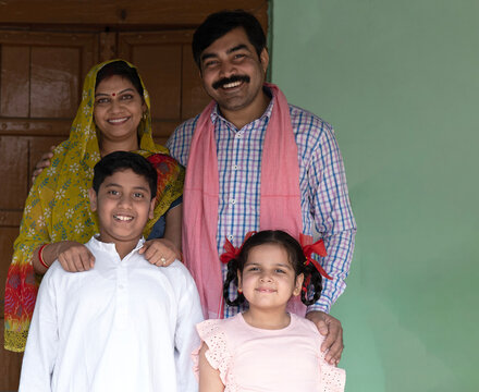 Indian happy rural family standing at the house village
