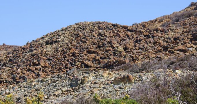 Slow zoom in to the roasted ore slag heap at mynydd parys mountain copper mine.