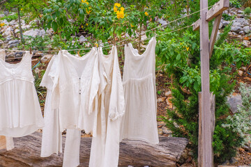 Different clothes drying on laundry line against garden background,clothes hanging laundry on washing line for drying towels drying on the clothesline.