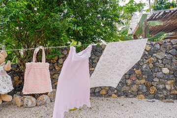 Different clothes drying on laundry line against garden background,clothes hanging laundry on washing line for drying towels drying on the clothesline.