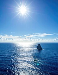 Vast ocean meets sky with a lone rock