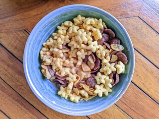 Colorful breakfast cereal with milk in a ceramic bowl