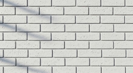 Fototapeta premium White brick wall with rectangular blocks, textured surface, and soft shadow casting diagonally across the upper left.
