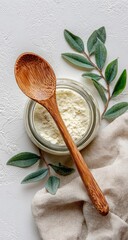 Light beige powder in a glass jar, with wooden spoon and leaves