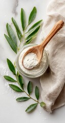 Powdered ingredient in glass jar, wooden spoon, and leaves