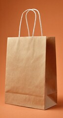 Light brown paper shopping bag against orange background