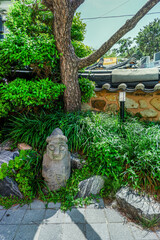 Dol Hareubang statues in beautiful jeju island,tangerine orchard and stone grandpa,main attractions of the korean,Traditional landmark for tourists.