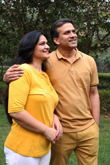 Indian young lovely couple hugging outdoors at the nature. Portrait of happy young indian couple fun together, husband wife morning walk outdoor. enjoying summer day outdoors. 