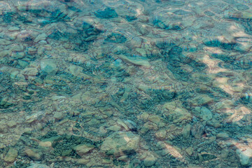 Rippling sea surface and rocky bottom of the Adriatic Sea. Marine background. Copy space.