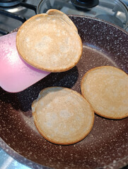 Pancakes are fried in a frying pan without oil.
