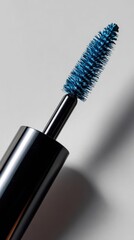 Naklejka premium Macro shot of a blue mascara brush with bristles coated in vibrant pigment, isolated on a clean white surface.