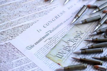 Obraz premium The second amendment and gun control in america concept. Bullets on american constitution