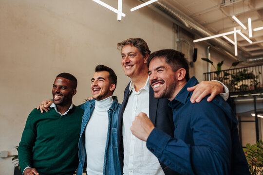 Happy business team celebrating success in modern office