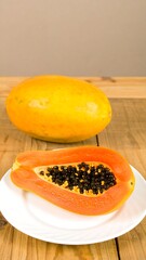 Ripe papaya, whole and sliced