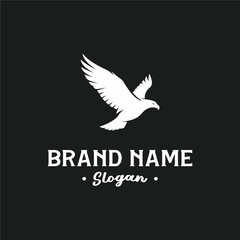 A minimalist logo design featuring a white flying eagle silhouette on a black background with placeholder text for brand name and slogan.