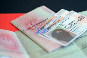 German Permanent resident card and temporary document lies on Germany flag