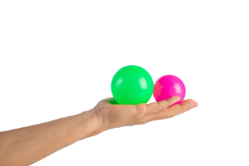 Pink and green plastic ball in hand, transparent background