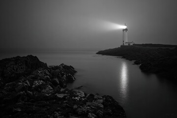 Lighthouse In Misty Coastal Scene