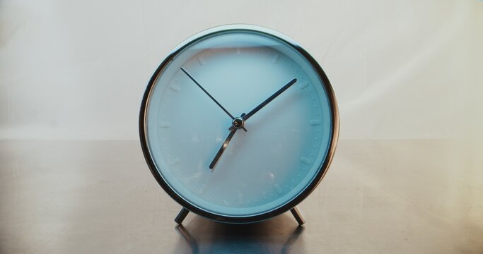 Close Up of Round Wall Clock with Minimalist Design on Warm Background with Moving Clock Hands Showing Precise Time. Modern Interior Decoration. Concept of Punctuality and Time Management. Time Lapse. - Powered by Adobe