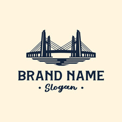 Classic logo design featuring a symmetrical cable-stayed bridge with towers reflected in the water below.