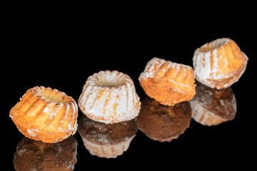Sweet homemade cupcakes isolated on black background, close-up.