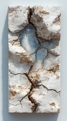 Discover the raw beauty of cracked earth texture with subtle gold accents and a glimpse of sky blue, perfect for dramatic backgrounds and artistic concepts.