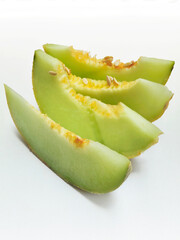 Fresh and Juicy Melon Wedges Displaying the Bright Green Flesh and Seeds