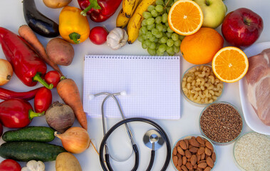 Diet Planning: Stethoscope, Notebook, and a Balanced Selection of Food